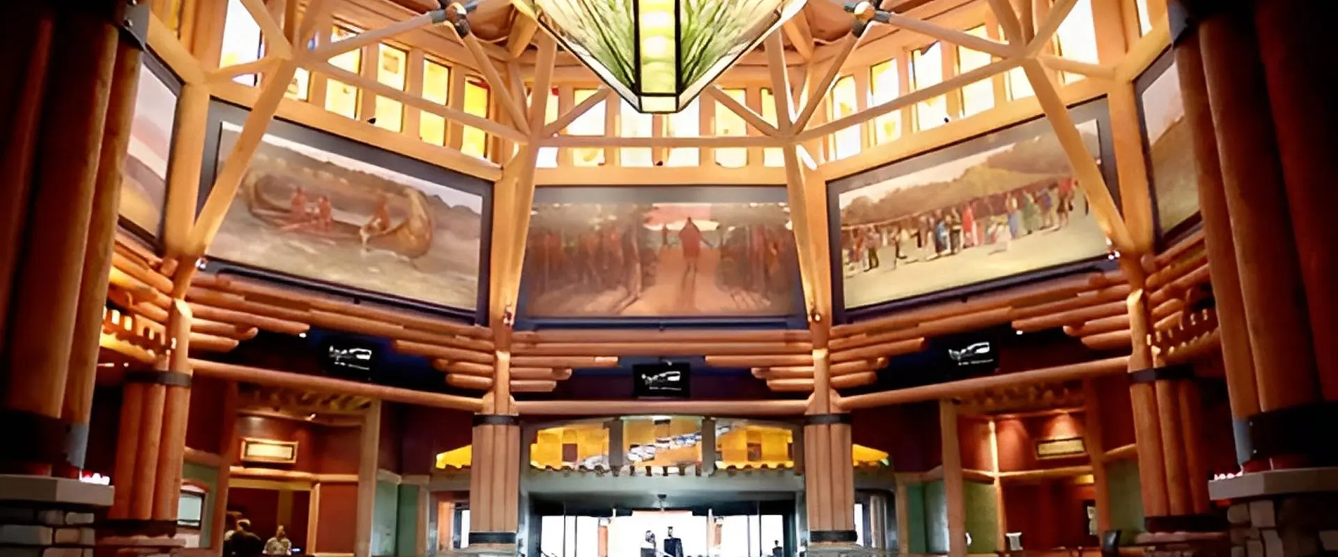 Spacious lobby with wooden beams and murals.