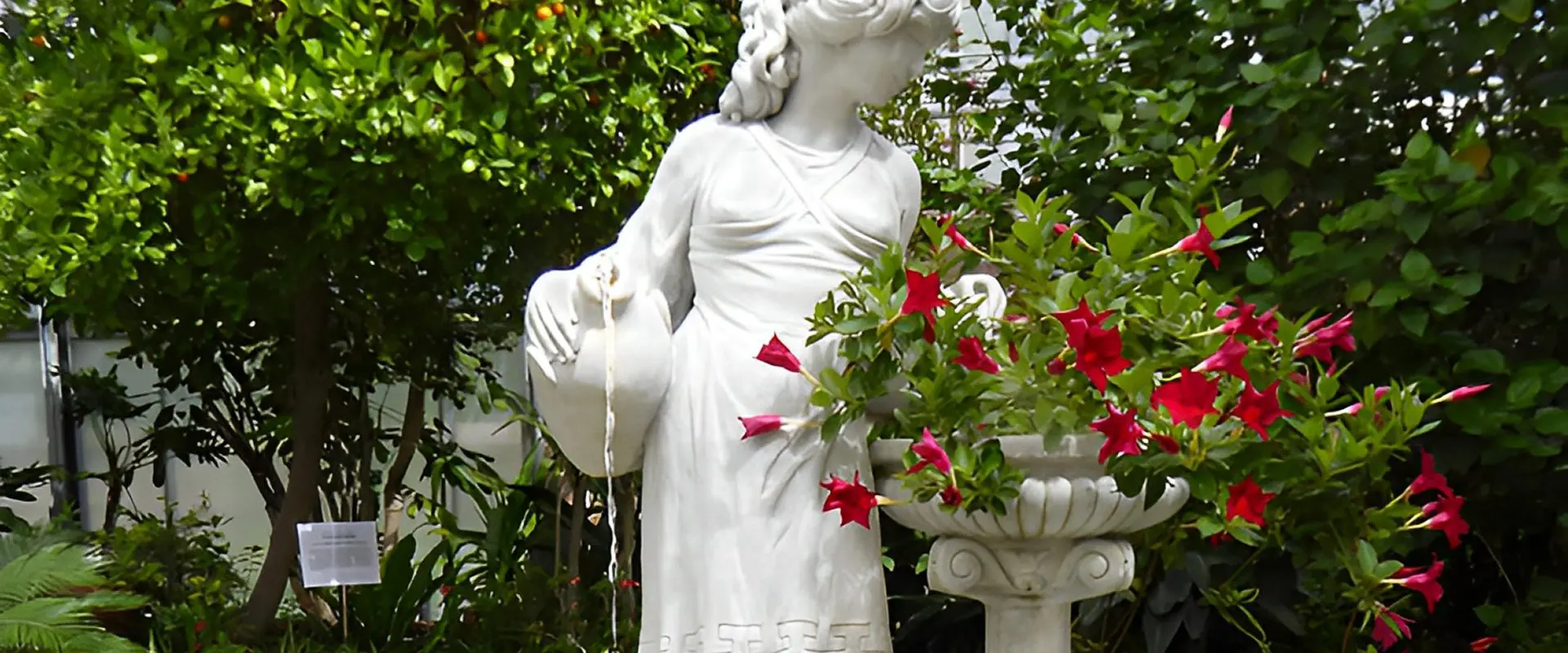 Statue of woman with flowers and jug.
