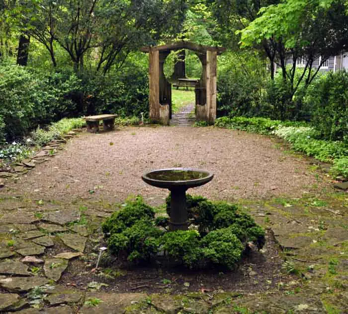 Tranquil garden path with stone bench.