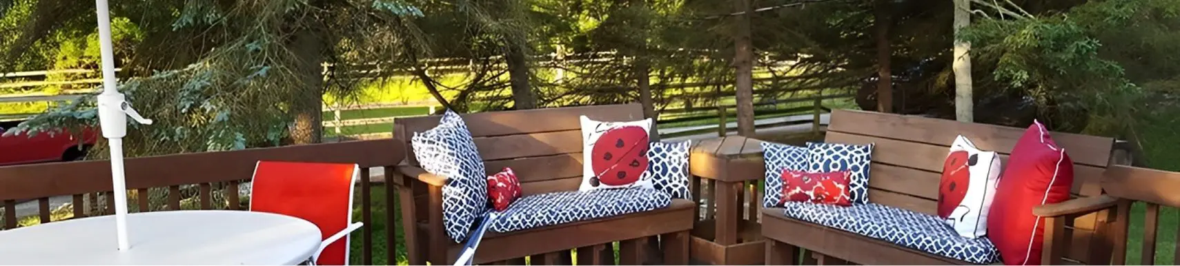 Outdoor patio with benches and cushions.